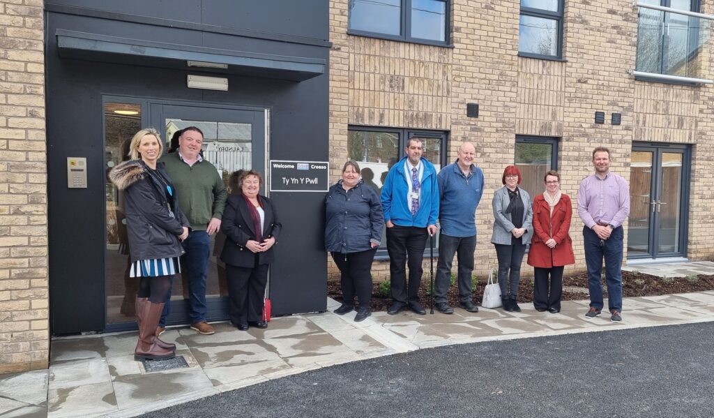 An image of United Welsh staff and local ward and community councillors stood outside the Ty Y Y Pwll apartment building in Trethomas