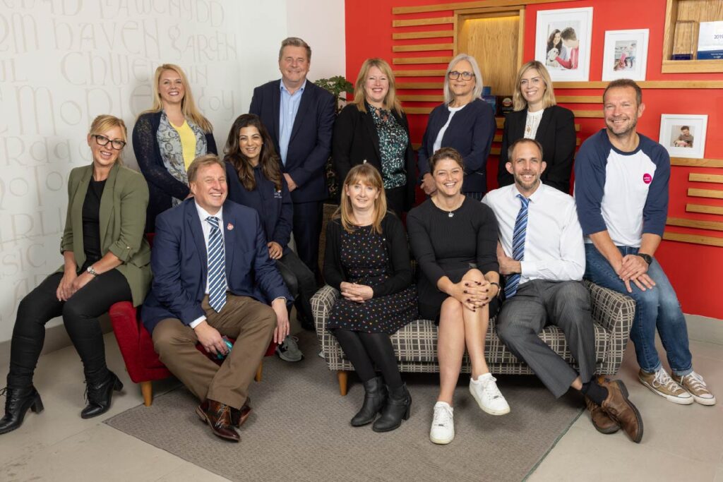 An image of staff members from housing associations in Wales smiling at the camera to announce the second year of the Get Into Housing project