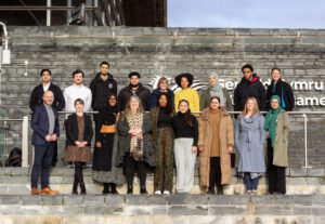 2024 cohort of the Get Into Housing project with Climate Change Minister Julie James on the steps of the Senedd. 