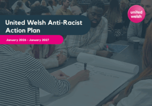 Cover of United Welsh Anti-Racist Action Plan January 2026 - January 2027. The photo shows United Welsh staff sitting around a table, writing on a big piece of paper.