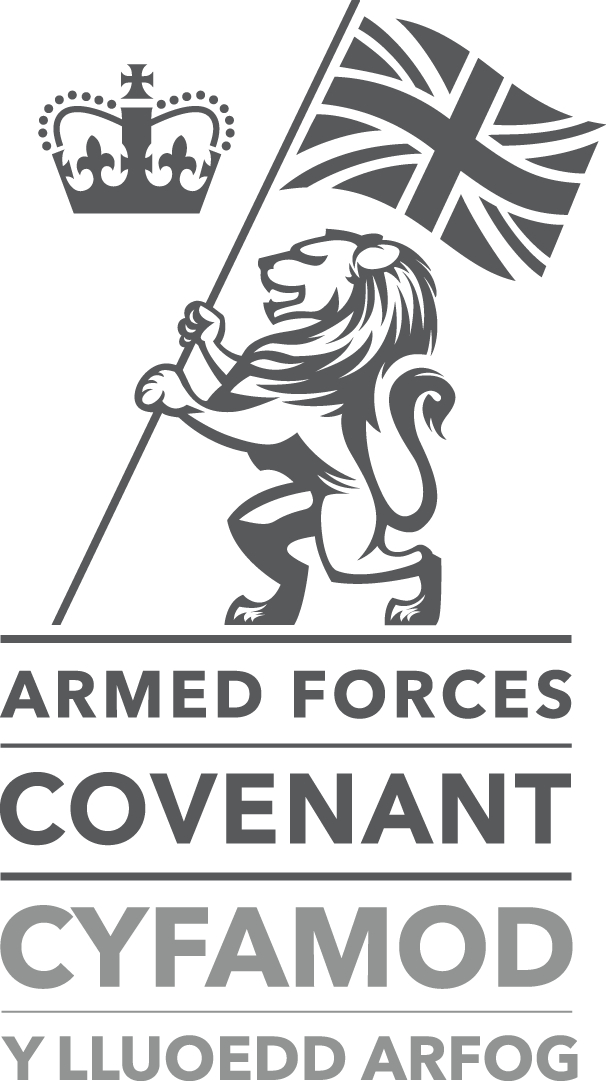 An image of the Armed Forces Covenant Bronze award logo. It shows an illustration of a grey lion carrying the union jack flag next to a crown.