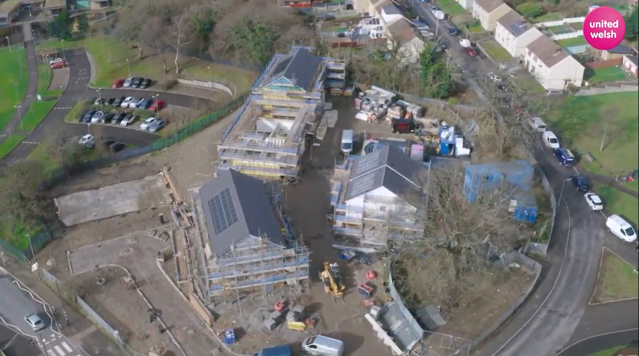 An aerial photo of the Cwm Ifor development site in Caerphilly. The houses are built but surrounded by scaffolding.