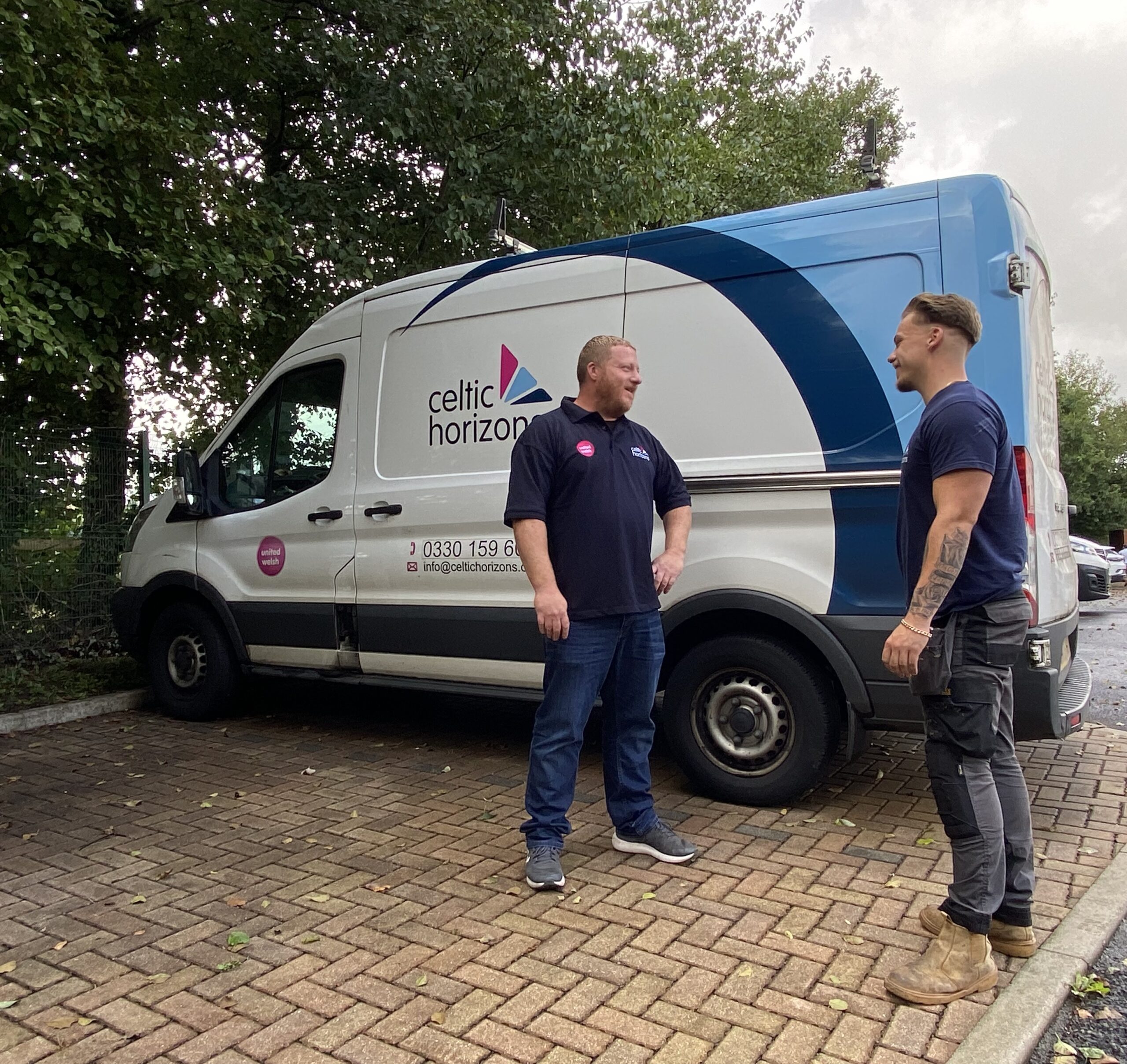 An image of Celtic Horizons staff talking to each other in front of a van