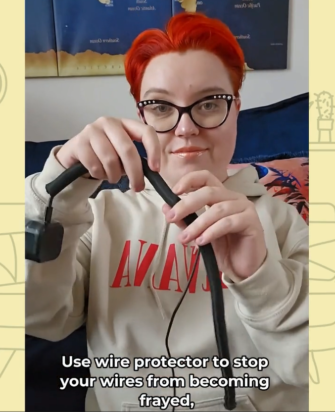 Photo of a woman putting wire protector on a phone charger.